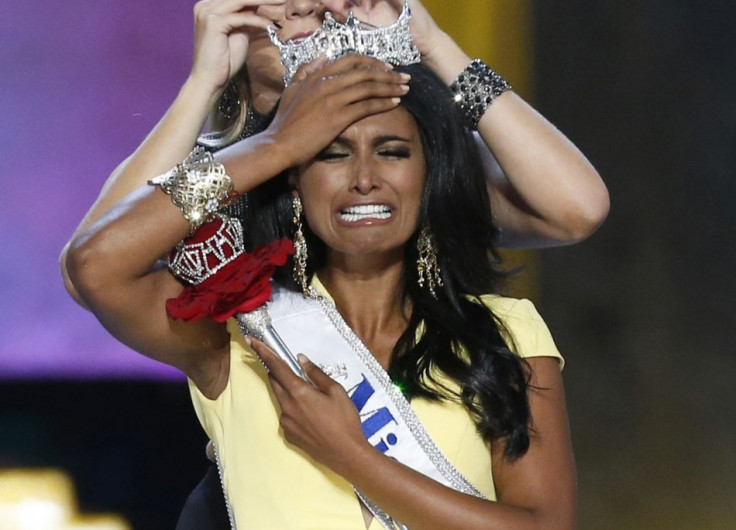 Miss America contestant, Miss New York Nina Davuluri reacts after being chosen winner of the 2014 Miss America Pageant as 2013 Miss America Mallory Hagan places a tiara on her head in Atlantic City, New Jersey, September 15, 2013. (REUTERS/Lucas Jackson)