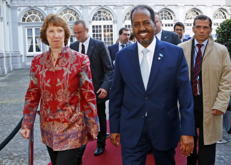 European Union foreign policy chief Catherine Ashton (L) and Somali's President Hassan Sheikh Mohamud (R) arrive at a conference called "New Deal in Somalia" in Brussels