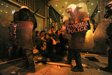Riot police officers detain protesters after clashes in the northern Greek town of Thessaloniki between police and angry anti-fascist protesters