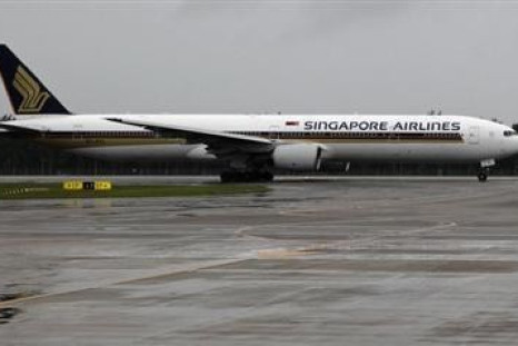 A Singapore Airlines Boeing 777-300 aircraft taxis on a runway at Changi airport on a rainy day in Singapore January 29, 2011.