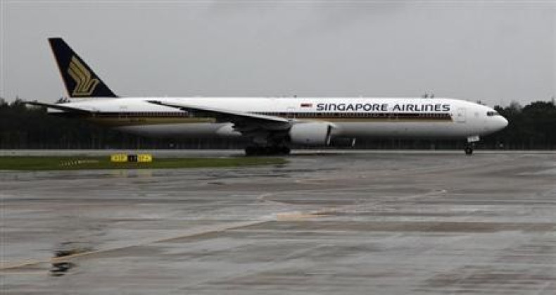 A Singapore Airlines Boeing 777-300 aircraft taxis on a runway at Changi airport on a rainy day in Singapore January 29, 2011.