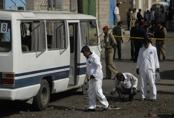 Forensic officers collect evidence at the scene of a roadside bomb attack on a military bus in Sanaa September 9, 2013