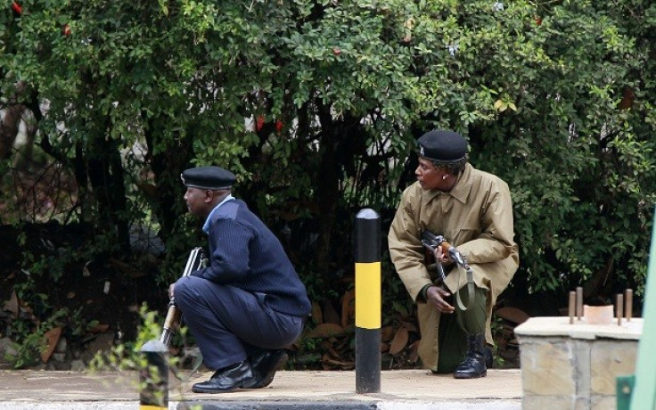 Kenyan police officers take positions during the ongoing military operation at the Westgate Shopping Centre in the capital Nairobi (Reuters)