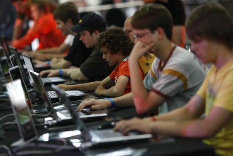 Teenagers and children at a computer games fair.