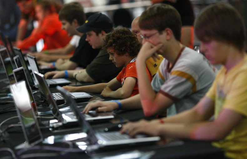 Teenagers and children at a computer games fair.
