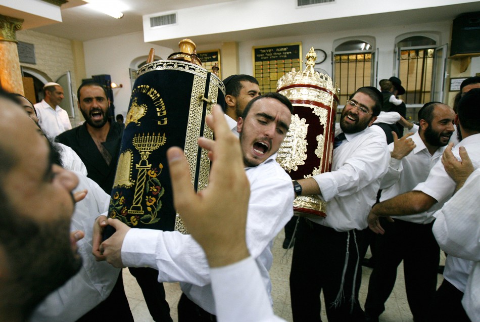 Ultra-Orthodox Jews dance with the Scroll of the Torah during the Jewish holiday of Simchat Torah at a synagogue in the Mea Shearim neighborhood of Jerusalem
