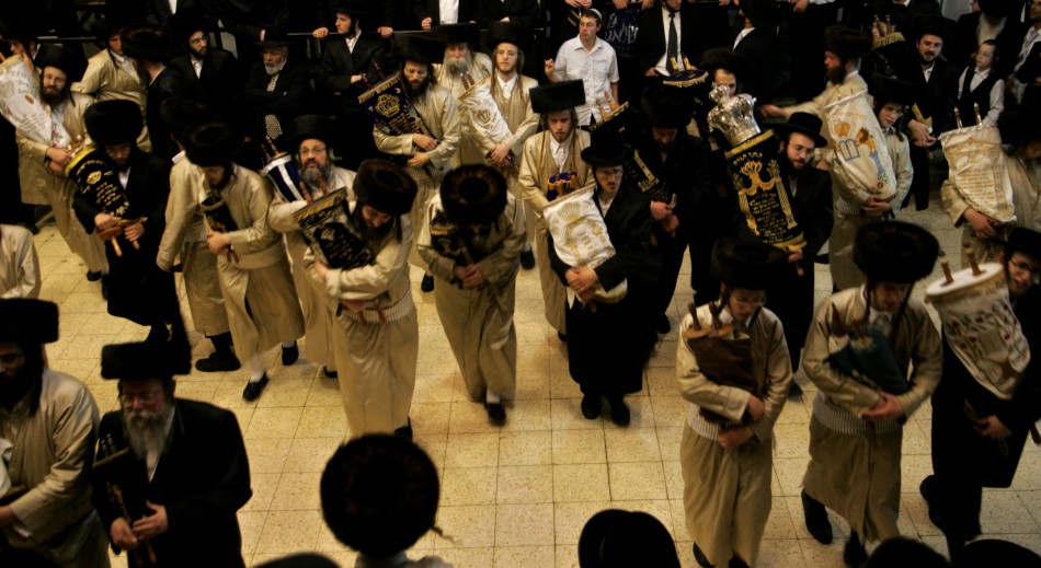 The synagogues Torah scrolls are removed from the ark and danced with during the ceremony
