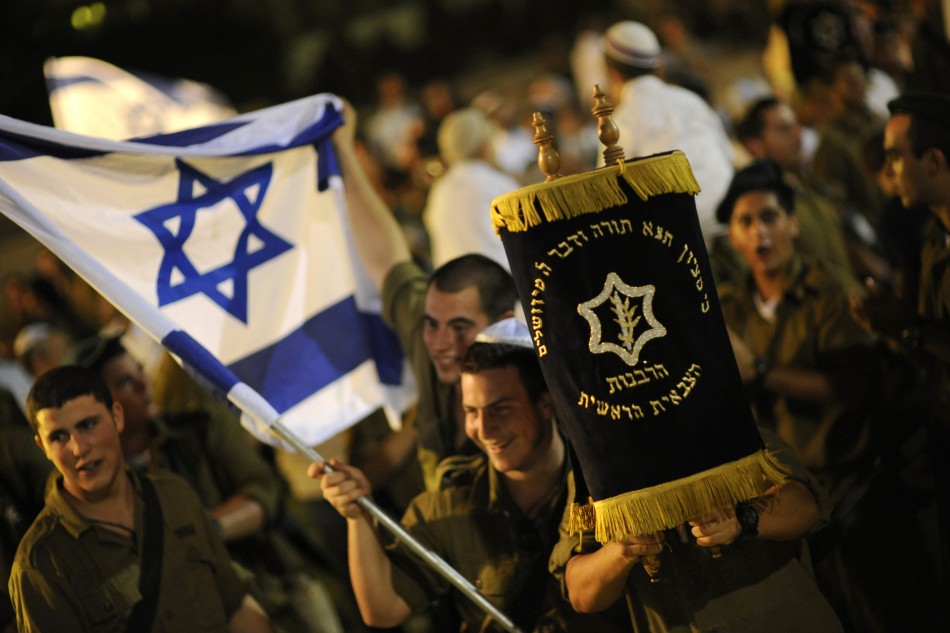 Israeli soldiers dance with Torah scrolls during the celebrations of Simchat Torah at the Eshkol regional council in the Negev