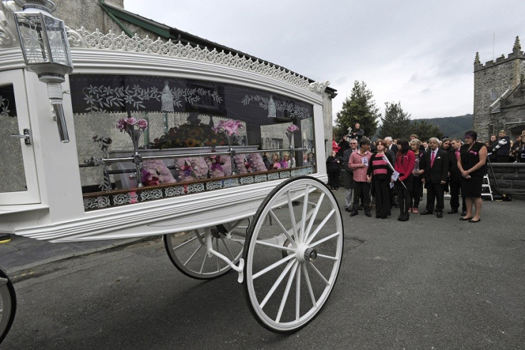 The coffin of April Jones is carried by a horse-drawn carriage following her funeral service at St Peter's Church in Machynlleth PIC: Reuters