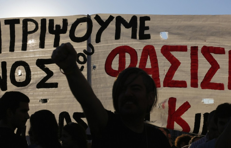 A protester raises his fist on a demonstration against the far-right Golden dawn organisation in Athens last night.