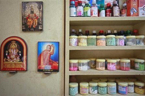 Pictures of Hindu gods hang beside a medicines rack inside a clinic in Pune August 27, 2012.