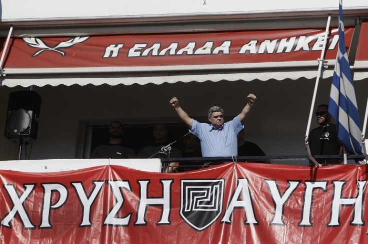 Nikolaos Michaloliakos gestures to supporters