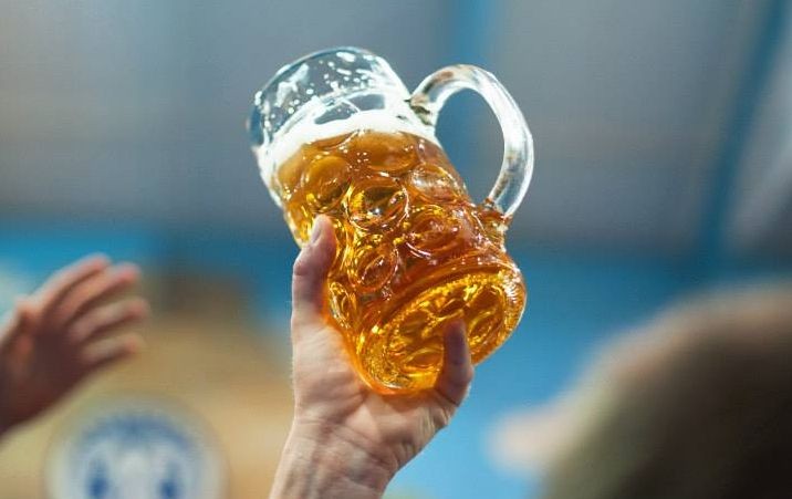 A visitor raises a toast with a beer mug at the 180th Oktoberfest in Munich, Germany. (Photo: Oktoberfest.de/Facebook)