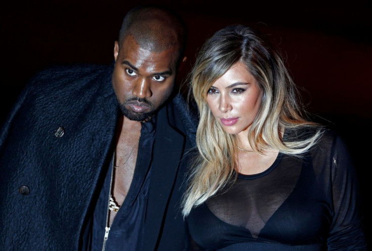 US musician Kanye West and companion Kim Kardashian arrive at the Givenchy Spring/Summer 2014 women's ready-to-wear fashion show during Paris Fashion Week September 29, 2013. (Photo: REUTERS/Charles Platiau)