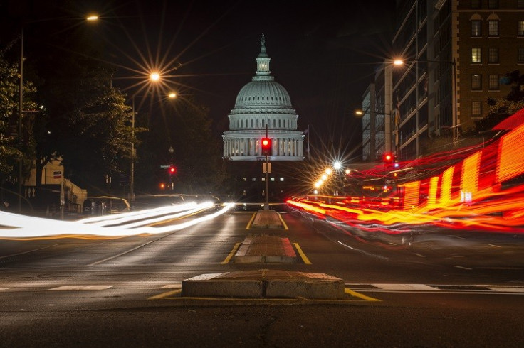 A red traffic light stands in front of the U.S. Capitol building. the US government partially shut down after a midnight deadline to approve a budget for 2014 passed despite an eleventh-hour appeal by President Barack Obama. (Photo: Reuters)