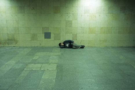 A homeless man sleeps on a platform in Budapest PIC: Reuters