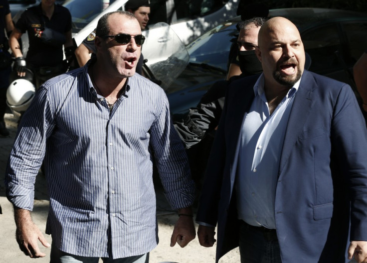 Extreme-right Golden Dawn party lawmakers Ilias Panagiotaros (R) and Nikos Michos yell at media people after being released in Athen