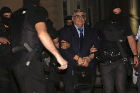Extreme-right Golden Dawn party leader Nikolaos Michaloliakos (C) is escorted by anti-terrorism police officers into a court house in Athens