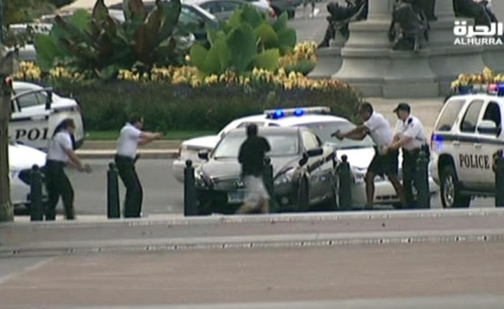 Black sedan is surrounded by officers with guns drawn near the White House PIC: Reuters