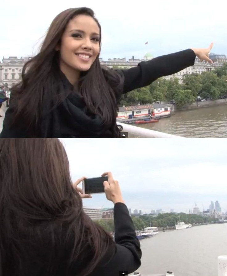 Megan Young points towards cathedral from Thames; she took a picture of it for the Miss World's Diary. (Photo: YouTube Video Screenshot/Miss World Organisation)