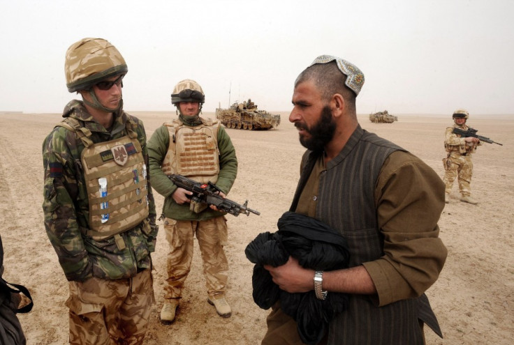Prince Harry talks with local man at checkpoint during tour of duty in Afghanistan PIC: Reuters