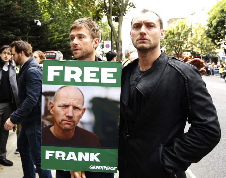 Damon Albarn (L) and Jude Law join protesters outside the Russian embassy in London.