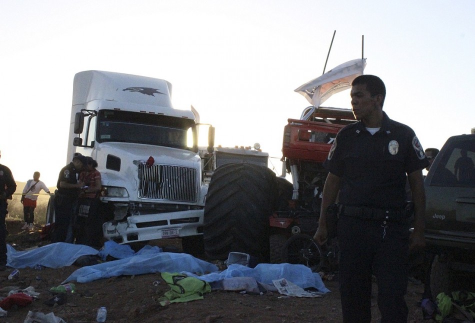 A police officer looks on as bodies lie covered withsheets after a monster truck ploughed into a crowd of spectators in Mexico. A police officer looks on as bodies lie covered withsheets after a monster truck ploughed into a crowd of spectators in Mexico.
