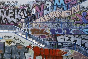 A man walks up a flight of stairs along walls covered in graffiti in Belgrade, Serbia (Photo: Reuters)