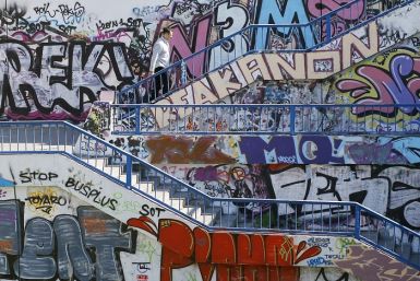A man walks up a flight of stairs along walls covered in graffiti in Belgrade, Serbia (Photo: Reuters)