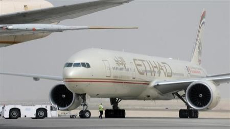 An engineer walks near an Etihad Airways aircraft at Abu Dhabi International Airport, September 19, 2012.