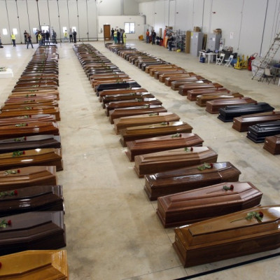 Coffins of victims from a shipwreck off Sicily are seen in a hangar of the Lampedusa airport