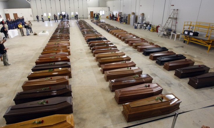 Coffins of victims from a shipwreck off Sicily are seen in a hangar of the Lampedusa airport