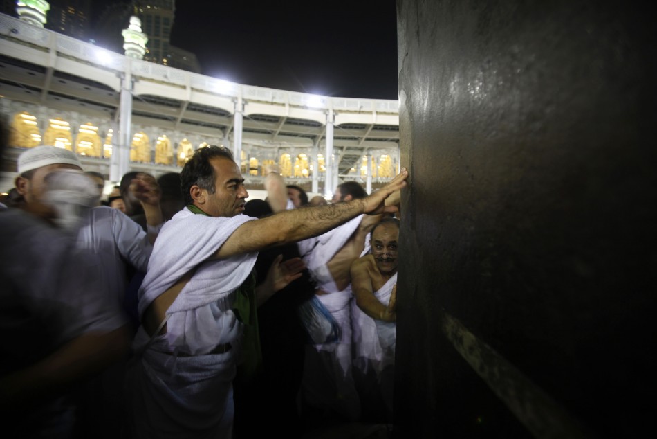 Muslim pilgrims touch the Kaaba at the Grand Mosque in the holy city of Mecca