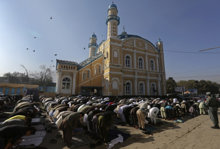 Afghan men attend Eid al-Adha prayers in Kabul