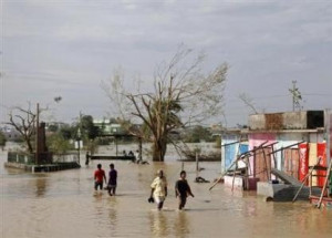 Residents wade through a flooded road after Cyclone Phailin hit Gopalpur in Ganjam district in the eastern Indian state of Odisha October 13, 2013. Residents wade through a flooded road after Cyclone Phailin hit Gopalpur in Ganjam district in the eastern Indian state of Odisha October 13, 2013.