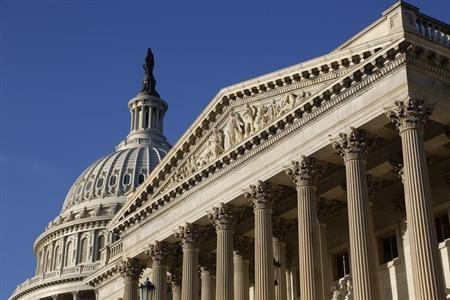 The sun rises on the U.S. Capitol in Washington, October 15, 2013.