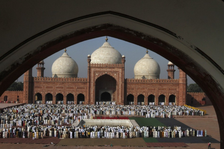 Pakistani Muslims attend a mass prayer for Eid al-Adha