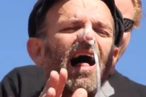 Andres Thomas Conteris grimaces as tube goes up his nose during Guantánamo Bay force-feeding protest