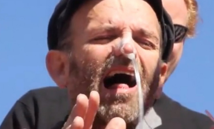 Andres Thomas Conteris grimaces as tube goes up his nose during Guantánamo Bay force-feeding protest