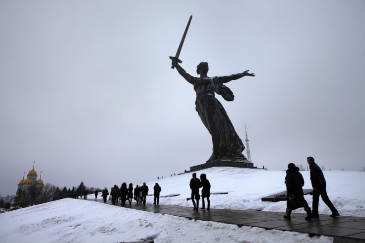 People walk at the Mamayev Kurgan (Mamayev Hill) World War Two memorial complex, with the statue of Mother Homeland in the background during celebrations in the city of Volgograd