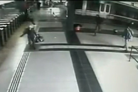 Bystanders flee as train mounts platform at Once station in Buenos Aries PIC: Youtube