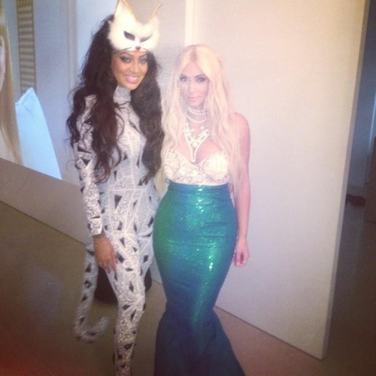 Dressed as a mermaid with blonde locks, pearls, a green fin and seashell bra [Kim Kardashian/Celebbuzz]