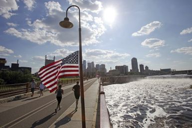 Runners cross the pedestrian-only stone arch bridge that crosses the Mississippi River downstream of the St. Anthony Falls (right) in Minneapolis, Minnesota. (Photo: Reuters)