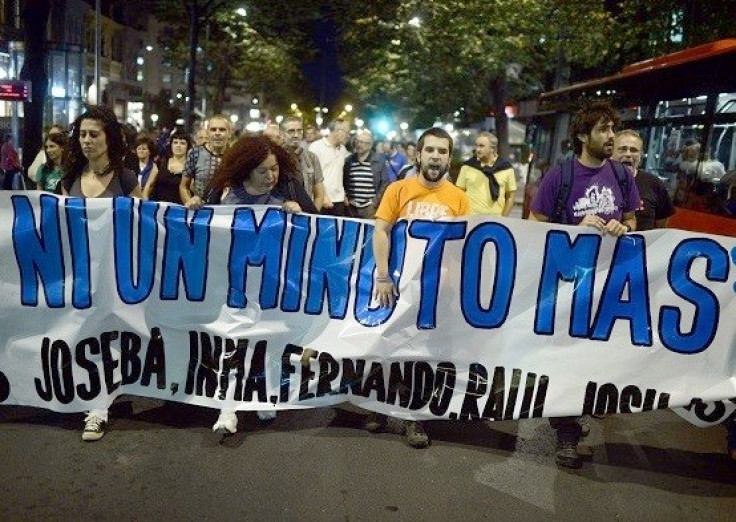 Supporters of ETA prisoners carry a protest banner during October 2013