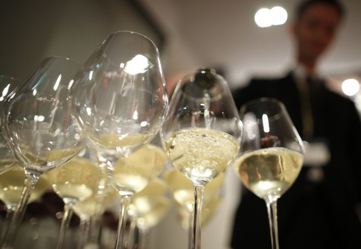 Tomonori Kakita, a sommelier-cum-concierge, demonstrates how to serve wine during a press preview at Wine Apartment in Tokyo