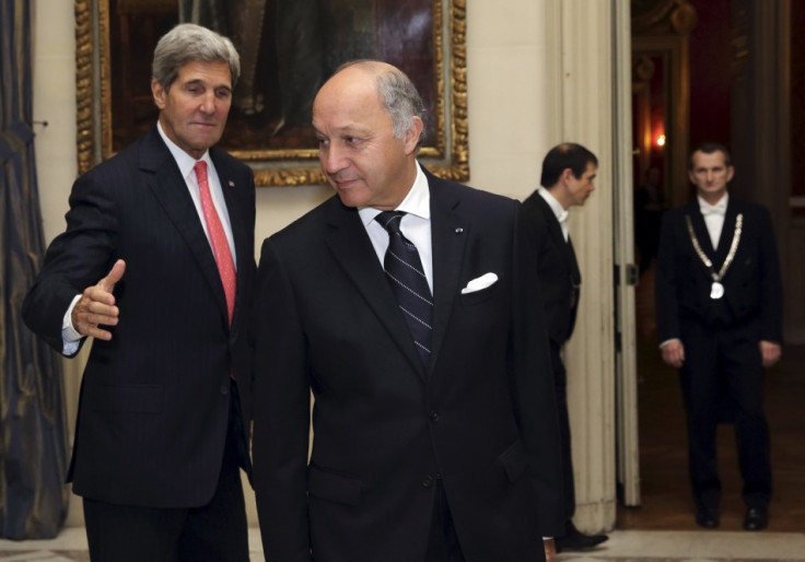 French Foreign Affairs Minister Laurent Fabius (C) welcomes U.S. Secretary of State John Kerry (L)
