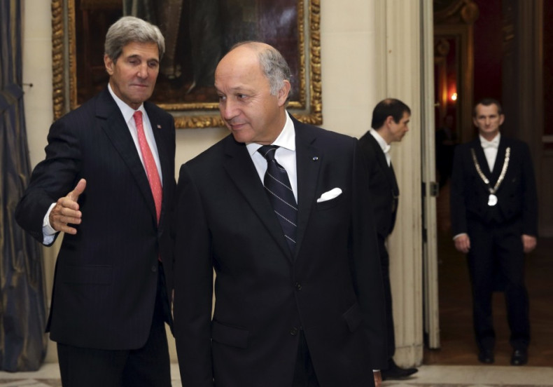 French Foreign Affairs Minister Laurent Fabius (C) welcomes U.S. Secretary of State John Kerry (L)