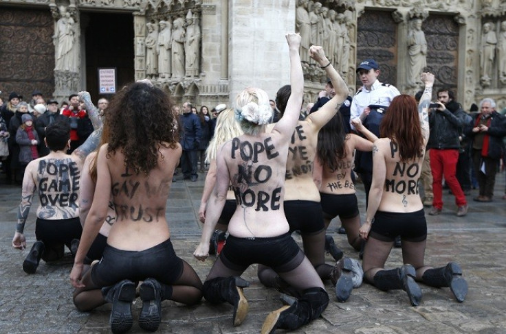 The group protests outside Notre-Dame de Paris Cathedral in Paris to celebrate French parliament’s approve a draft law allowing same-sex marriage (Reuters)
