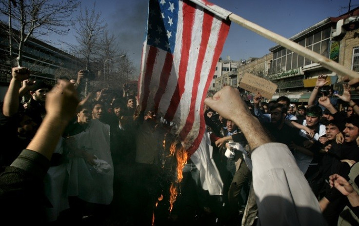 Iranian protestors burn a US flag during a protest in Tehran.