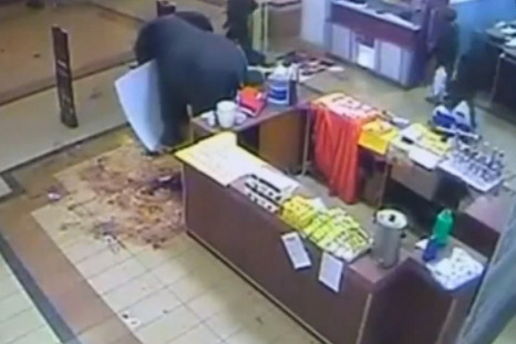 CCTV footage shows Kenyan security forces walking out of the Westgate mall holding white plastic bags heavy with items (YouTube)